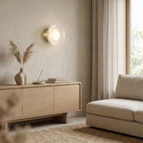 Row of ribbed disc wall lights along a white corridor wall