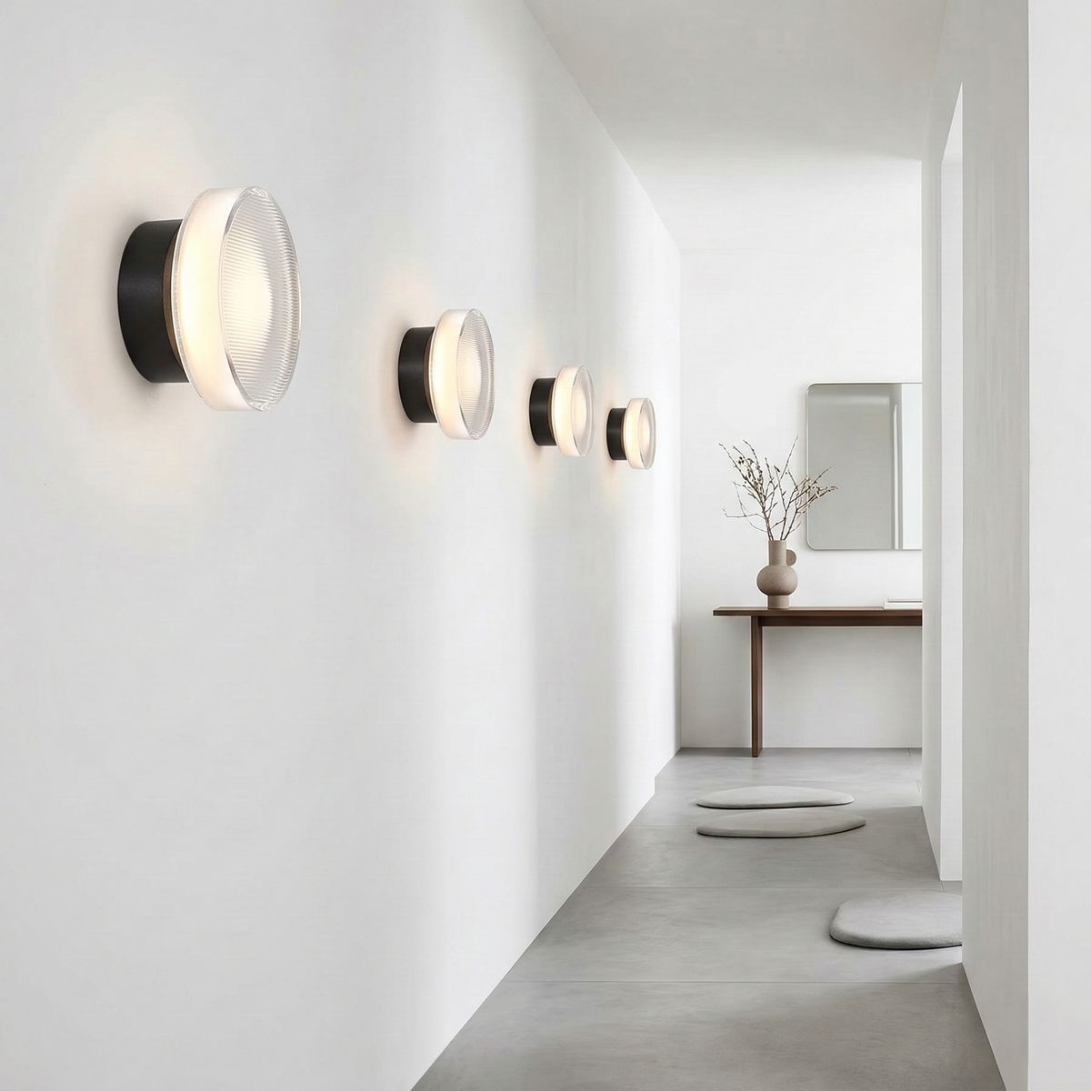 Gold ribbed wall light lit above a desk with a laptop and plant