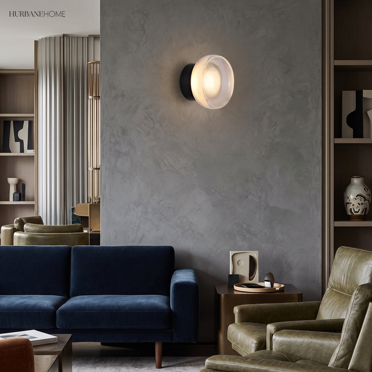 Gold ribbed disc wall light lit on a grey wall in a living room