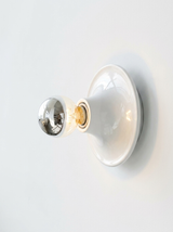 Two white disc lights, one seen face on and one from the side