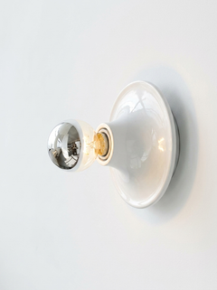 Two white disc lights, one seen face on and one from the side