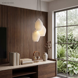 Two ribbed ceramic pendants against a dark timber slatted feature wall