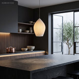Ribbed ceramic teardrop pendant above a dark kitchen with stone benchtop