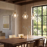 Cluster of fluted glass pendants above a walnut table and cane chairs