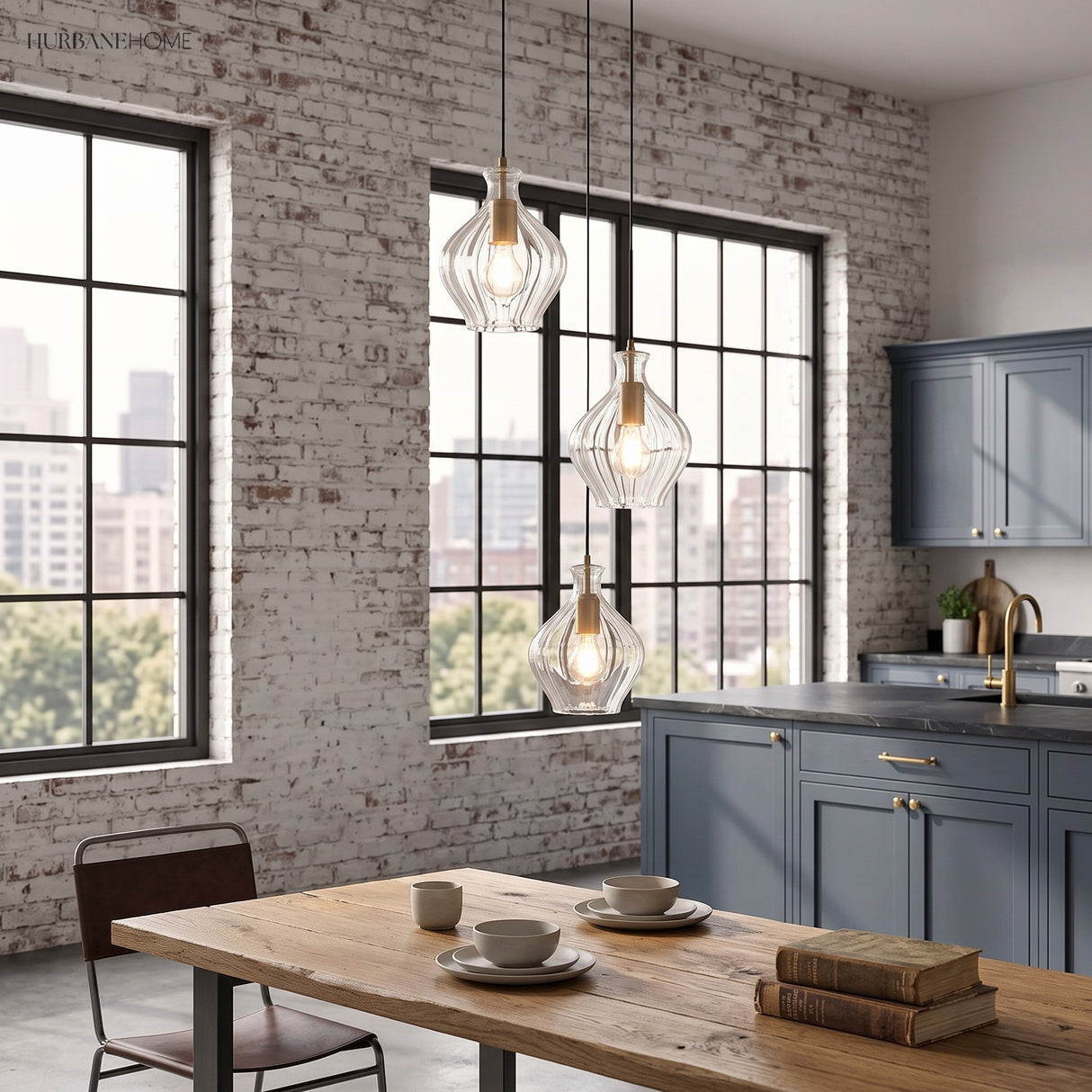 Fluted glass pendants above a kitchen island in a brick walled loft