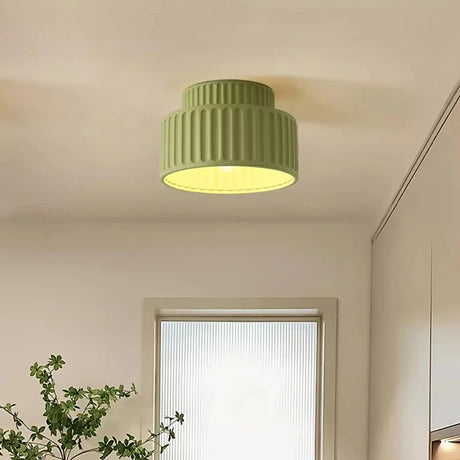 Fluted semi flush mount ceiling light shown switched off on a plain background