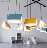 Open book pendant lights lighting a bright modern interior space