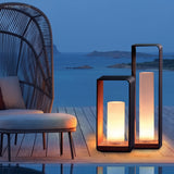 Square frame outdoor lawn bollard light in a garden setting