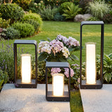 Square frame outdoor lawn bollard light in a garden setting