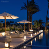 Square frame outdoor lawn bollard light in a garden setting
