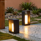 Square frame outdoor lawn bollard light in a garden setting