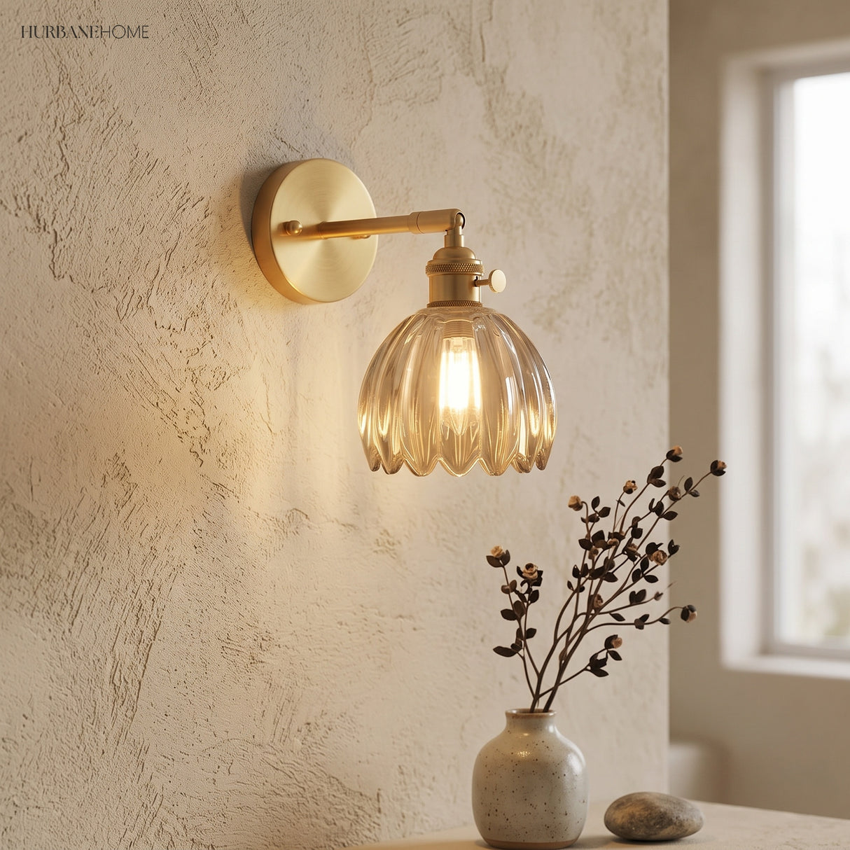Amber lotus glass wall sconce on a textured plaster wall