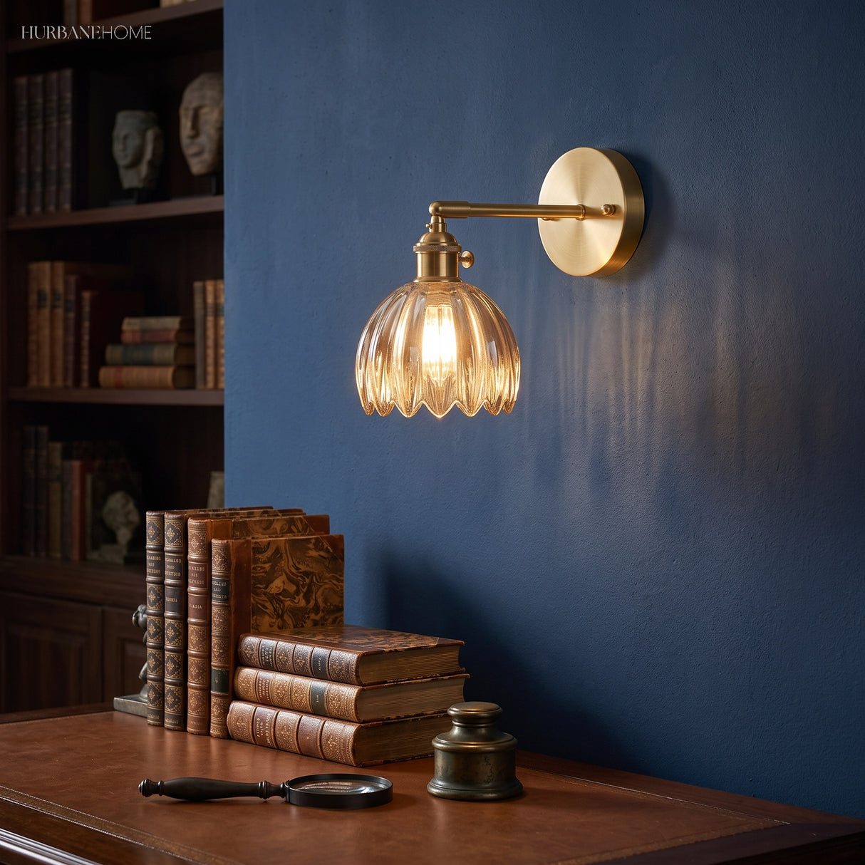 Amber lotus glass wall sconce above a study desk