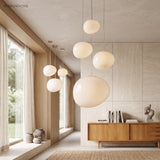 Five pebble pendants staggered along a timber lined hallway