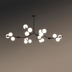 Black branch chandelier lit against a dark background showing its spread