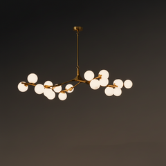 Gold branch chandelier lit against a dark background showing its spread