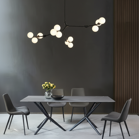 Black branch chandelier above a grey dining table and four chairs