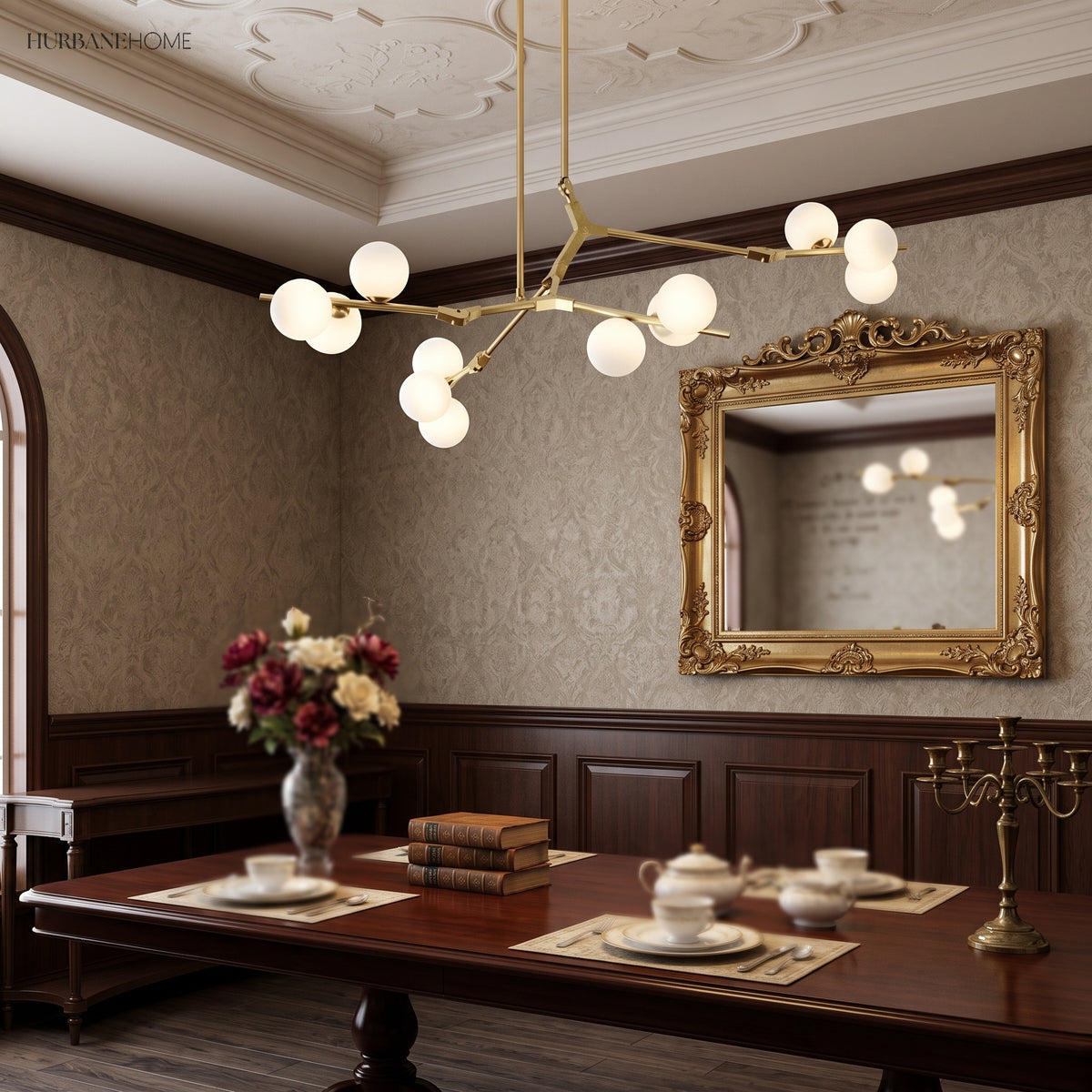 Gold branch chandelier above a dark wood dining table and gilt mirror