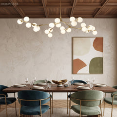 Gold branch chandelier beneath a coffered timber ceiling above a dining table