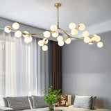 Gold branch chandelier lit above grey sofas in a bright living room