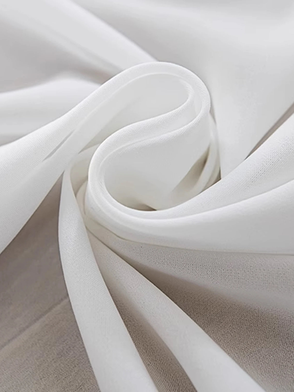 Gauzy white curtains flowing lightly across bay window frame