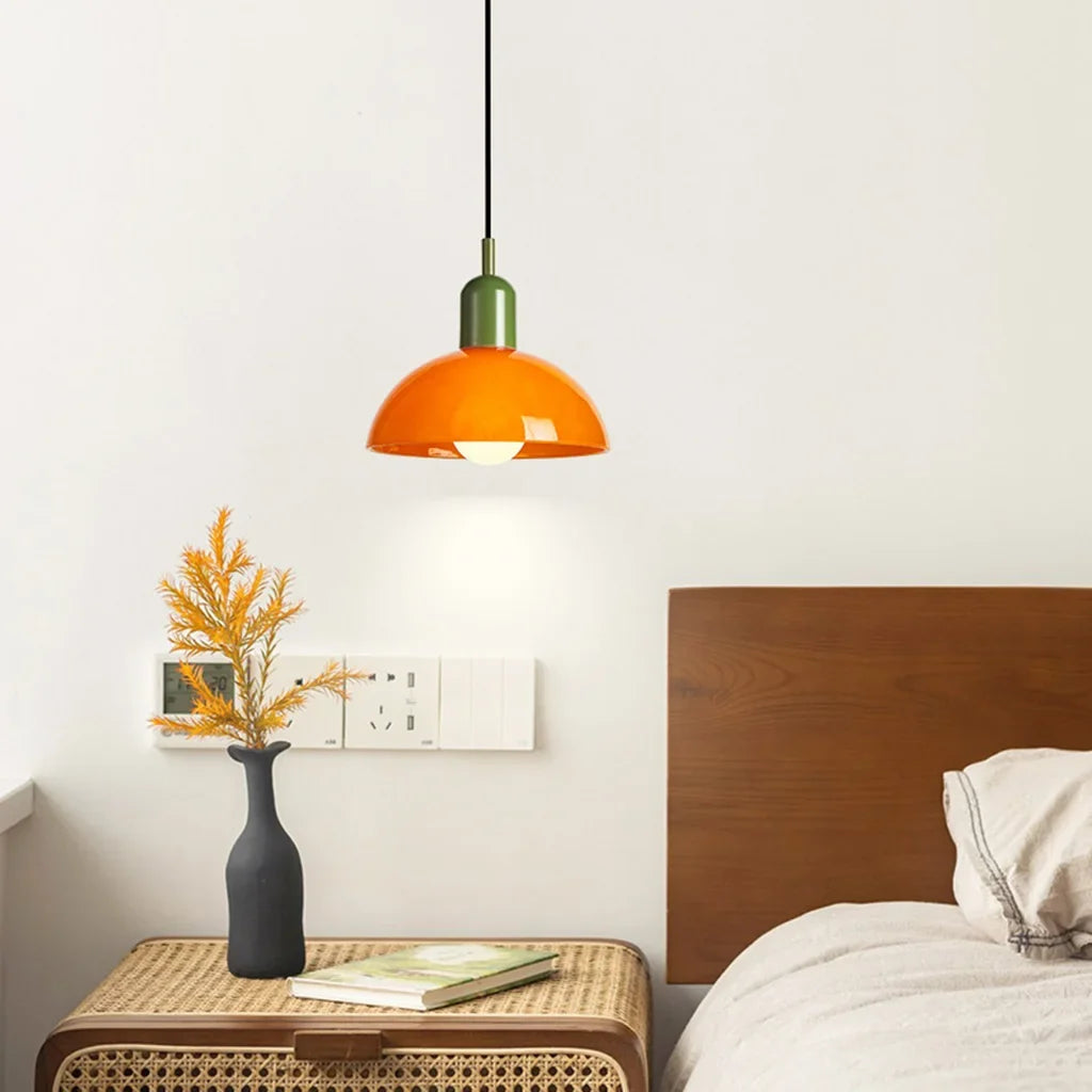 Bowl pendant light lit up showing warm glow through the glossy glass shade