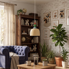 Glass dome pendant lit in a brick walled room with a navy velvet sofa