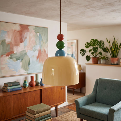 Beige glass dome pendant light hung from red, green and blue wooden beads