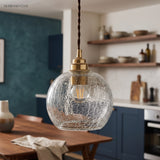 Crackle sphere pendant in a teal kitchen with open timber shelves