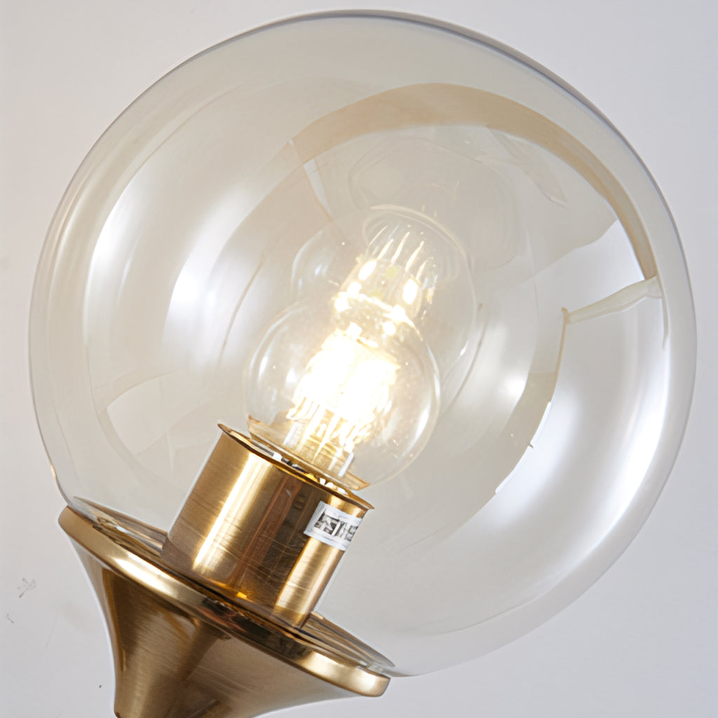 Close detail of a glass globe wall sconce backplate and stem