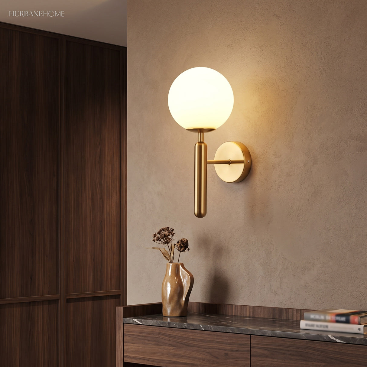 Gold sconce with a milk glass globe beside a dark wood wardrobe