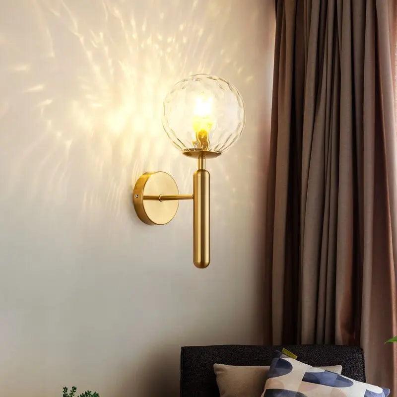Gold ripple glass sconce lit beside heavy curtains in a living room