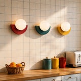 Modern glass globe wall sconce styled in a calm interior setting