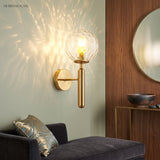 Ripple glass sconce casting a starburst light pattern above a sofa