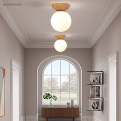 Glass globe semi-flush ceiling light in a styled interior