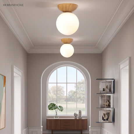Glass globe semi-flush ceiling light in a styled interior