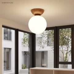 Glass globe semi-flush ceiling light in a styled interior
