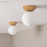 Glass globe semi-flush ceiling lights in a styled interior