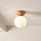Glass globe semi-flush ceiling light with wooden mount, product photo