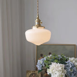 Glass pendant hanging light styled above kitchen island