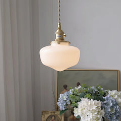 Glass pendant hanging light styled above kitchen island