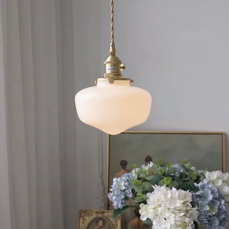 Glass pendant hanging light styled above kitchen island