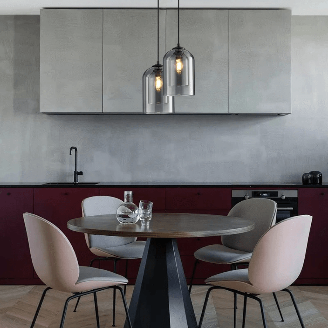 Two double glass pendants above a round dining table