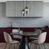 Two double glass pendants above a round dining table