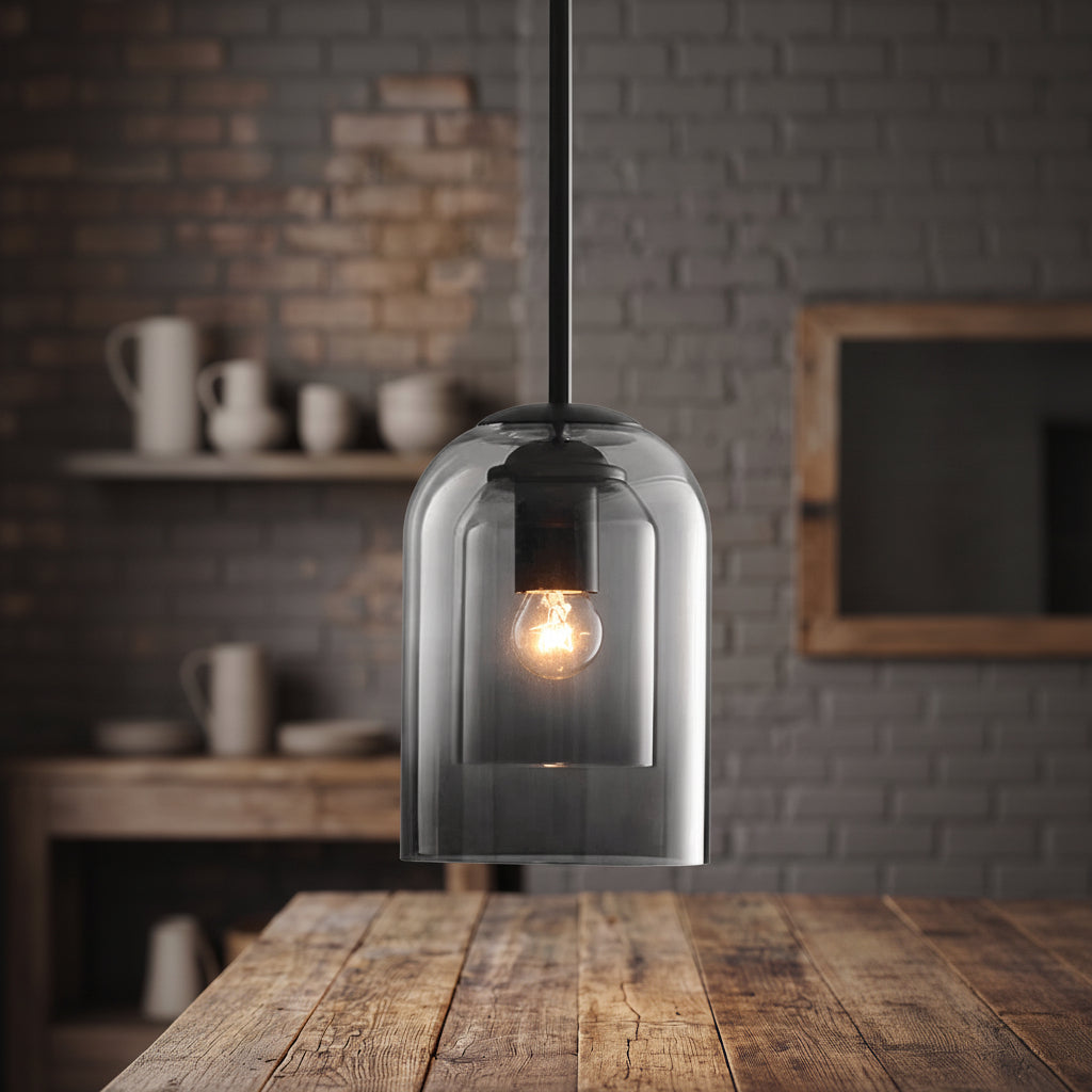 Double glass pendant with a smoke outer shade above a wood table