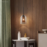 Smoke glass pendant lit against a walnut panelled wall