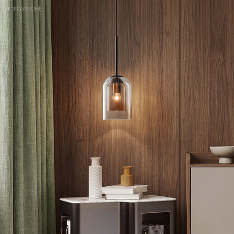 Smoke glass pendant lit against a walnut panelled wall