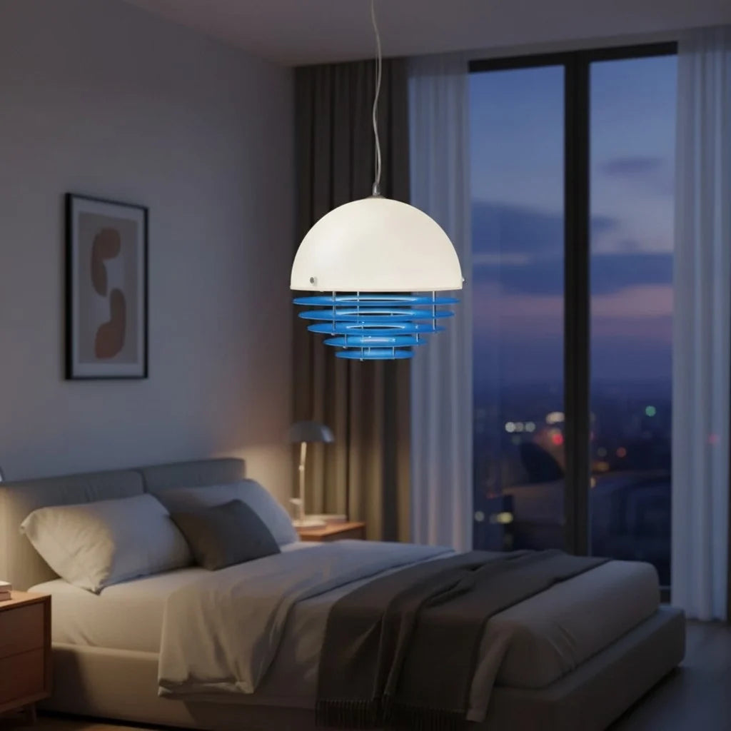 Ring-shade pendant seen against a plain wall with a warm glow