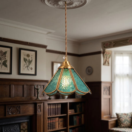 Blue panelled glass pendant with a scalloped brass frame lit in a panelled room