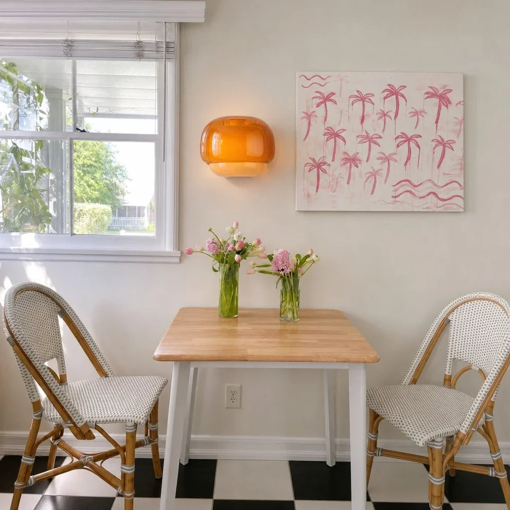 Glass wall sconce paired with wood panelling and neutral decor accents